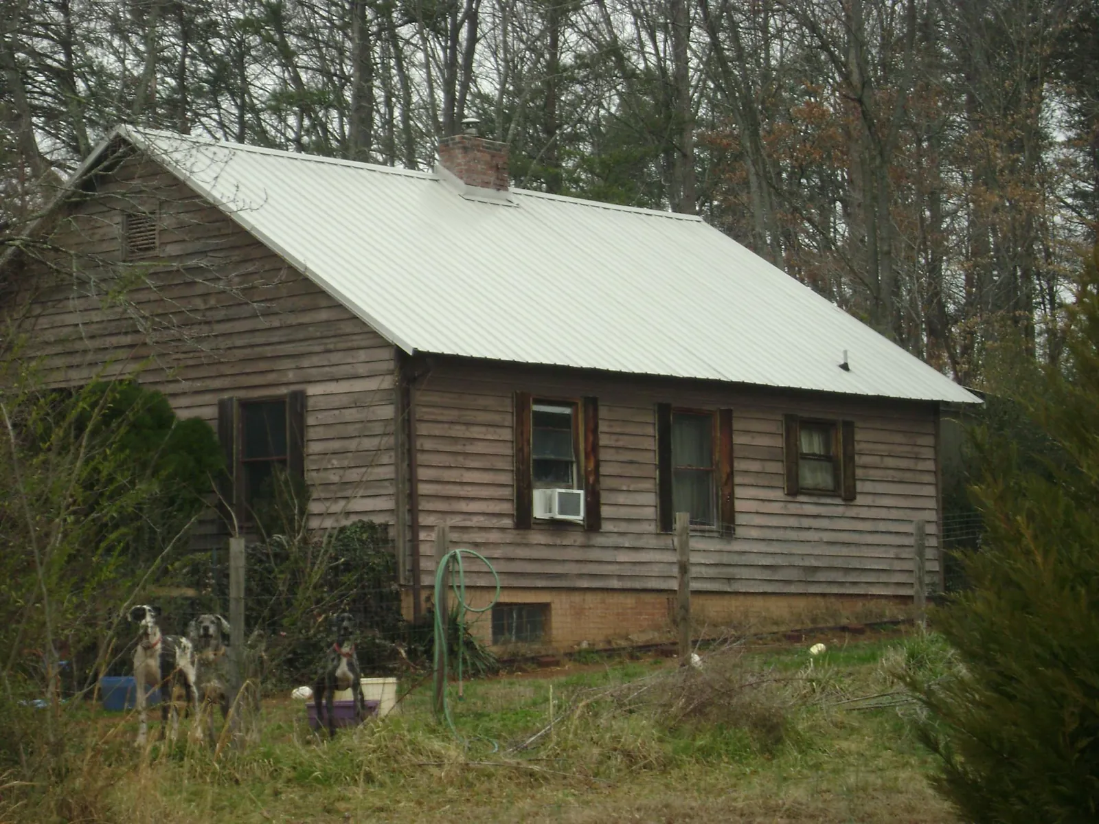 White metal roof on an old wood sided farmhouse, from a Metal Roof Installation job in Conway